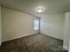 Cozy bedroom with plush carpet and a window offering natural light at 11505 Sweetbriar Ridge Dr, Charlotte, NC 28269
