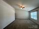 Bedroom features neutral carpet, walls, and ceiling fan providing a calming and inviting space at 11505 Sweetbriar Ridge Dr, Charlotte, NC 28269