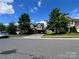 Two-story home with neutral siding, red shutters, a two-car garage, and a well-maintained lawn at 11505 Sweetbriar Ridge Dr, Charlotte, NC 28269