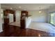 Open-concept kitchen with wood cabinets, granite countertops, and modern appliances at 11505 Sweetbriar Ridge Dr, Charlotte, NC 28269
