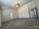 Spacious living room featuring neutral carpet and modern ceiling fan at 11505 Sweetbriar Ridge Dr, Charlotte, NC 28269
