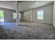 Open-concept living room with decorative columns and ample natural light at 11505 Sweetbriar Ridge Dr, Charlotte, NC 28269