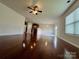 Bright living room with hardwood floors, ceiling fan, and neutral walls, adjacent to the kitchen area at 11505 Sweetbriar Ridge Dr, Charlotte, NC 28269
