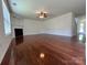 Spacious living room with hardwood floors, a cozy fireplace, and ample natural light at 11505 Sweetbriar Ridge Dr, Charlotte, NC 28269