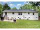 This backyard features a fire pit, patio and furniture for outdoor enjoyment at 1218 E Woodlawn Rd, Charlotte, NC 28209