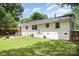 This backyard features a fire pit, patio and furniture for outdoor enjoyment at 1218 E Woodlawn Rd, Charlotte, NC 28209