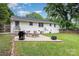 This backyard features a fire pit, patio and furniture for outdoor enjoyment at 1218 E Woodlawn Rd, Charlotte, NC 28209