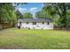 Spacious backyard with a well-manicured lawn, patio area, and fenced perimeter for added privacy at 1218 E Woodlawn Rd, Charlotte, NC 28209