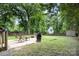 Outdoor patio area with furniture, grill, and a lush green lawn, perfect for entertaining at 1218 E Woodlawn Rd, Charlotte, NC 28209