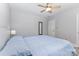 Comfortable bedroom with ceiling fan, complemented by a bed with a blue comforter for a peaceful ambiance at 1218 E Woodlawn Rd, Charlotte, NC 28209