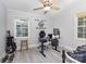 This bedroom features a ceiling fan, with gray flooring and a desk for work space at 1218 E Woodlawn Rd, Charlotte, NC 28209