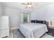 Comfortable bedroom with a ceiling fan and a large window for plenty of natural light at 1218 E Woodlawn Rd, Charlotte, NC 28209