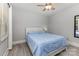 Cozy bedroom featuring a ceiling fan and a comfortable bed with blue comforter, creating a relaxing space at 1218 E Woodlawn Rd, Charlotte, NC 28209