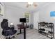 Bedroom with a ceiling fan and natural light, with gray flooring and desk for work space at 1218 E Woodlawn Rd, Charlotte, NC 28209