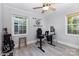 Bedroom with a ceiling fan, complemented by natural light streaming through the windows and a desk for work at 1218 E Woodlawn Rd, Charlotte, NC 28209