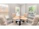 Cozy dining area with updated lighting fixture, warm paint color, bright, natural light, and seating for four at 1218 E Woodlawn Rd, Charlotte, NC 28209