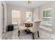Cozy dining area featuring updated lighting fixture, warm paint color, with bright, natural light, and seating for four at 1218 E Woodlawn Rd, Charlotte, NC 28209