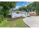 Well-maintained exterior with fresh paint, a new driveway, updated landscaping, and a cozy, inviting curb appeal at 1218 E Woodlawn Rd, Charlotte, NC 28209