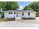 Charming single-story home featuring a freshly painted exterior, tidy landscaping and a newly updated driveway at 1218 E Woodlawn Rd, Charlotte, NC 28209