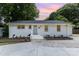 Charming single-story home featuring a freshly painted exterior, tidy landscaping and a newly updated driveway at 1218 E Woodlawn Rd, Charlotte, NC 28209