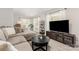 Comfortable living room with ample light, sleek entertainment center, stylish decor and calming color palette at 1218 E Woodlawn Rd, Charlotte, NC 28209