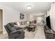 Spacious living room with wood-look floors, large sectional couch, recliner, and bright natural light at 1218 E Woodlawn Rd, Charlotte, NC 28209