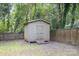 Backyard storage shed with a double door, offering extra storage space and functionality at 1218 E Woodlawn Rd, Charlotte, NC 28209