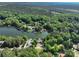 Expansive aerial shot of a home nestled among trees with a lake, offering scenic beauty and privacy at 126 Strand Rd, New London, NC 28127