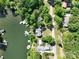 Breathtaking aerial view of a lakefront property with lush greenery and direct water access at 126 Strand Rd, New London, NC 28127