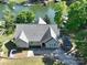 Aerial view of a beautiful home featuring a stone pathway, lush lawn, gray roof, and matching shed on the property at 126 Strand Rd, New London, NC 28127