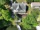 Aerial view of a lakeside home with a large deck, private dock, and steps leading to the tranquil water at 126 Strand Rd, New London, NC 28127