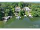 Aerial view of lakefront homes with private docks and decks, offering an idyllic setting and direct water access at 126 Strand Rd, New London, NC 28127