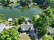 Aerial view of a charming home on the lake with a private dock surrounded by lush trees, ideal for lakeside living at 126 Strand Rd, New London, NC 28127