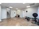 Spacious basement featuring concrete floors, access to stairs, and a dedicated workout area with weights at 126 Strand Rd, New London, NC 28127