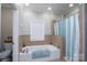 Bathroom featuring a tiled shower and separate soaking tub at 126 Strand Rd, New London, NC 28127