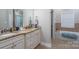Well-lit bathroom featuring double sink vanity with beige cabinets, and separate tub and shower at 126 Strand Rd, New London, NC 28127