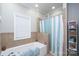 Bright bathroom featuring a tiled shower and soaking tub at 126 Strand Rd, New London, NC 28127