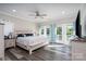 Bright bedroom with french doors to balcony, light wood floors, and a modern ceiling fan at 126 Strand Rd, New London, NC 28127