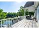 Scenic deck featuring a dining table, grill, and lake views at 126 Strand Rd, New London, NC 28127
