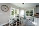 Bright dining area with large windows, a classic chandelier, and a view of the backyard at 126 Strand Rd, New London, NC 28127