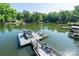 Well-maintained dock with a pontoon boat and jet skis, offering a fun lakeside experience at 126 Strand Rd, New London, NC 28127