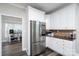 Modern kitchen with stainless steel refrigerator and stylish white cabinets at 126 Strand Rd, New London, NC 28127
