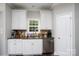Charming kitchen featuring white cabinetry, stainless steel dishwasher, and a stainless steel sink at 126 Strand Rd, New London, NC 28127