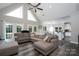 Open-concept living room with vaulted ceilings, large windows, and stylish, neutral toned furniture at 126 Strand Rd, New London, NC 28127