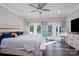 Light-filled main bedroom boasts ceiling fan and balcony access through French doors at 126 Strand Rd, New London, NC 28127