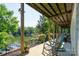 Covered patio with rocking chairs offering serene lake views at 126 Strand Rd, New London, NC 28127