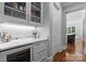 Chic bar area with custom cabinetry, wine storage, and stylish countertop at 12835 Ninebark Trl, Charlotte, NC 28278