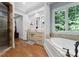 Well-lit bathroom with a soaking tub, double sinks, granite countertops, and decorative fixtures at 12835 Ninebark Trl, Charlotte, NC 28278