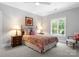 Cozy bedroom featuring a comfortable bed, neutral walls, and great natural light from a window at 12835 Ninebark Trl, Charlotte, NC 28278