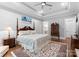 Comfortable bedroom with a decorative rug, a wooden bed frame, and access to the en-suite bathroom at 12835 Ninebark Trl, Charlotte, NC 28278